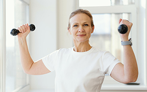 shot woman holding dumbbells