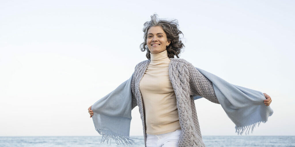 older-woman-enjoying-her-time-beach