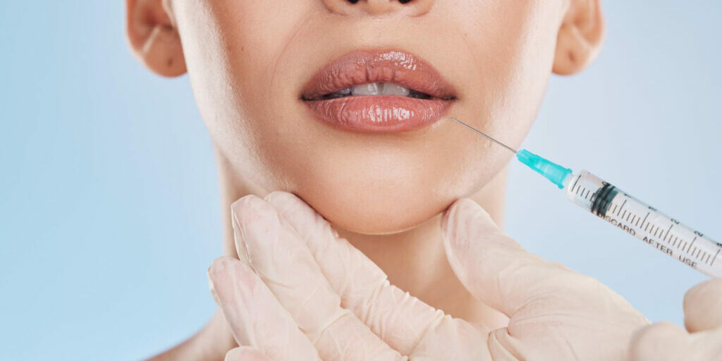 plastic-surgery-collagen-lip-filler-facial-beauty-aesthetic-medical-cosmetic-surgery-hands-face-augmentation-surgeon-doctor-working-patient-client-lips-with-injection-needle